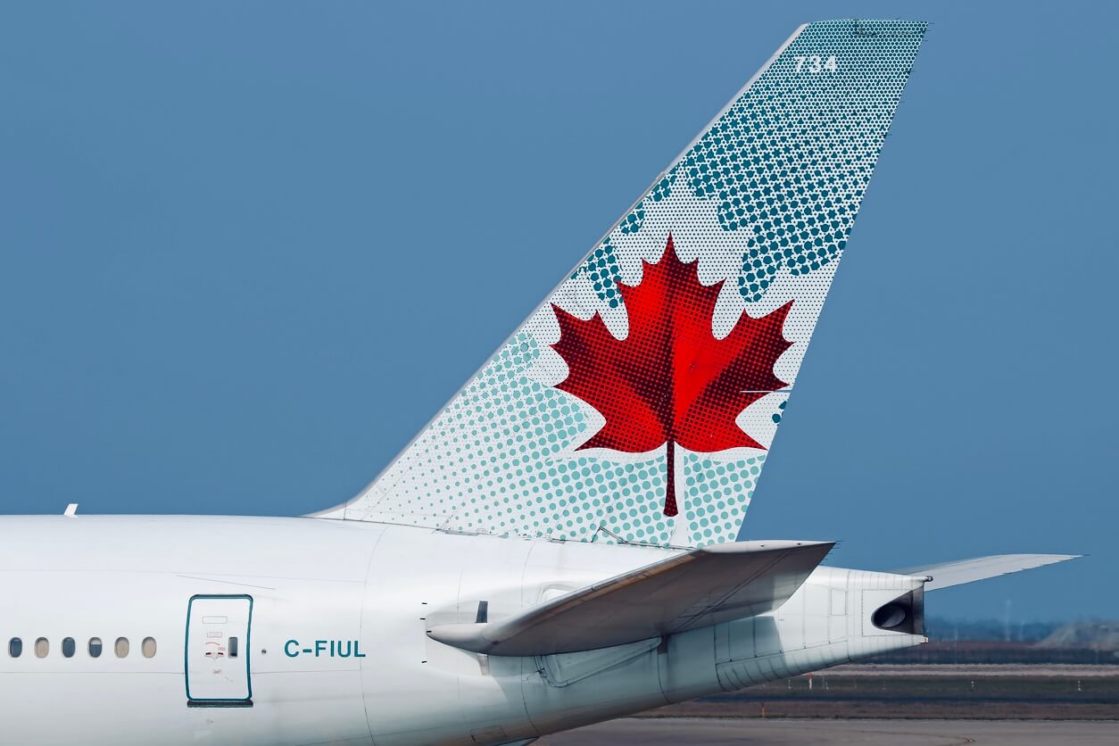An Air Canada airplane tail featuring a Canadian maple leaf design, with registration "C-FIUL".